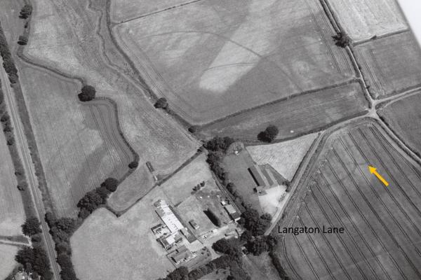 Bronze age barrow and prehistoric Pinn Brook enclosure seen from the air